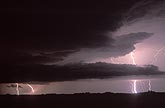 Storms clouds silhouetted by brilliant lightning