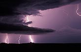 A brilliant lightning bolt pierces through the base of a storm 