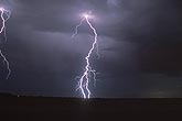 A jagged single lightning bolt with blue and pink filaments