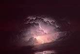 Intracloud lightning illuminates the dome of a storm cloud like a light bulb