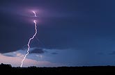 Close-up of a single cloud-to-ground lightning bolt at twilight
