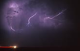 Forked wisps of lightning dart in and out 