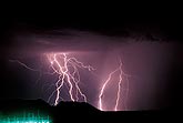 A tangle of lightning bolts dwarfs a power relay station