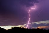 A single elegant lightning bolt adds brilliance to a colorful sunset