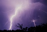 A close, white-hot lightning bolt rips through the sky