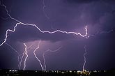 Horizontal lightning with bolts over city