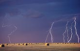 Rare beaded lightning bolt (bead lightning) in a hayfield in daylight