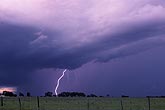 A single cloud-to-ground lightning bolt in daylight