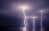 Lightning bolts with branches over water
