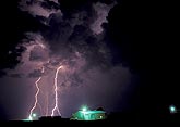 Clouds churn as cloud-to-ground lightning strikes
