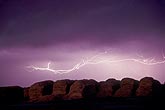 Horizontal lightning streamers over hay bales