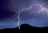 Lightning discharge: mountain is struck by lightning after charge buildup
