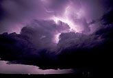 Cumulus Congestus clouds silhouetted by lightning (intracloud)