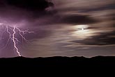 A strange, surreal scene with a lone lightning bolt in moonlight