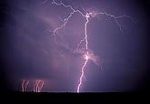 A close branching lightning discharge spears a small cloud patch
