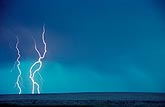 Cloud-to-ground lightning in a turquoise daylight sky