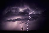 An anvil lightning bolt shoots out along an irregular path
