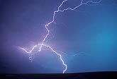 Rare looped and knotted lightning discharge in a deep turquoise sky 
