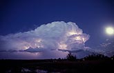 A ghostly Cumulonimbus storm cloud with full moon and lightning