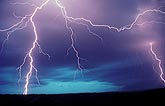 Exquisitely detailed lightning strikes in a turquoise and purple sky 
