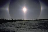 Bright, colorful sundogs in air filled with ice crystals (diamond dust)