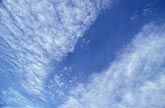 High sweeps of Altocumulus clouds arc across an abstract skyscape