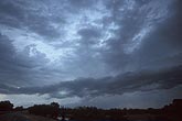 A low threatening dark cloud in a stormy sky