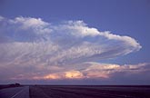 A storm anvil cloud evaporating in the twilight