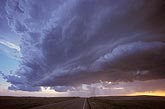 A shelf cloud or Arcus accompanies the gust front of a high-based storm