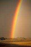 A very brilliant rainbow lights up a farmer
