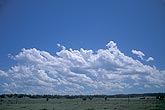 Carefree clouds romp across a rural landscape