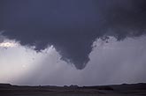 A tapered, funnel-shaped wall cloud extension