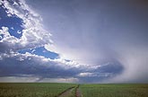 A draping rain curtain graces an elegant storm in a magical cloudscape