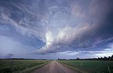 An unusual low cloud is a focal point for updrafts into a passing storm