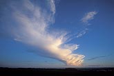 An anvil plume from a distant cloud floats carefree