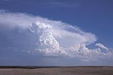 Cumulus Congestus tower on the outflow of a distant Cumulonimbus