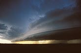 A deep, sculpted Arcus cloud precedes a squall line in a stormy sky