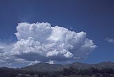A clump of Cumulus Congestus clouds form over high land
