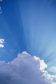 Rays of God (crepuscular rays) burst from a cloud top