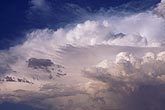 A skyscape with strips and layers of billowing clouds