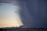 A heavy curtain of rain shrouds mountains in the desert