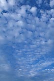 Soft puffy clouds shimmer in a peaceful skyscape