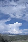 A distant cumuliform cloud mass matures into a storm as it builds up