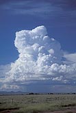 A boiling Towering Cumulus cloud looms over an arid landscape