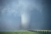 A large and dangerous tornado with a murky swirl of debris