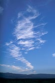 A fan of cloud wisps draws us toward the freedom of open space