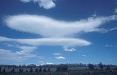 Altocumulus patches transformed into lenticular clouds by local hills