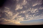 Silver-edged Mammatus cloud bulges from a storm’s anvil 