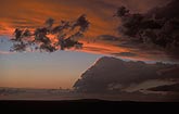 A surreal twilight sky with orange storm cloud