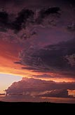 Purple, rose and amber light on storm clouds in a sunset sky